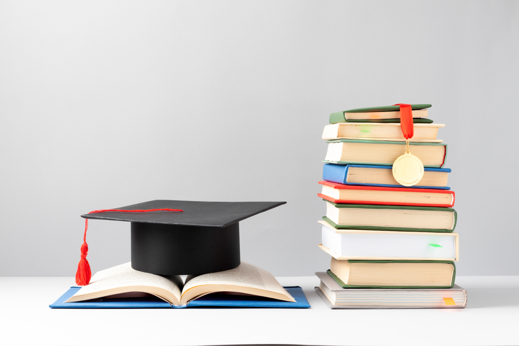 front-view-stacked-books-graduation-cap-open-book-education-day